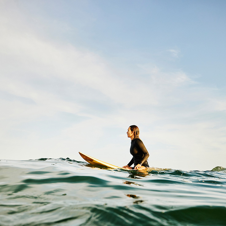 Surfer sitting on board in the ocean