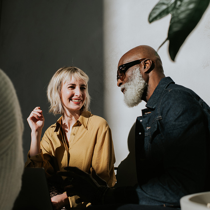 Woman and man speaking over computer