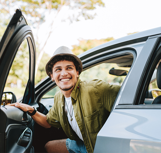 Young man getting out of car