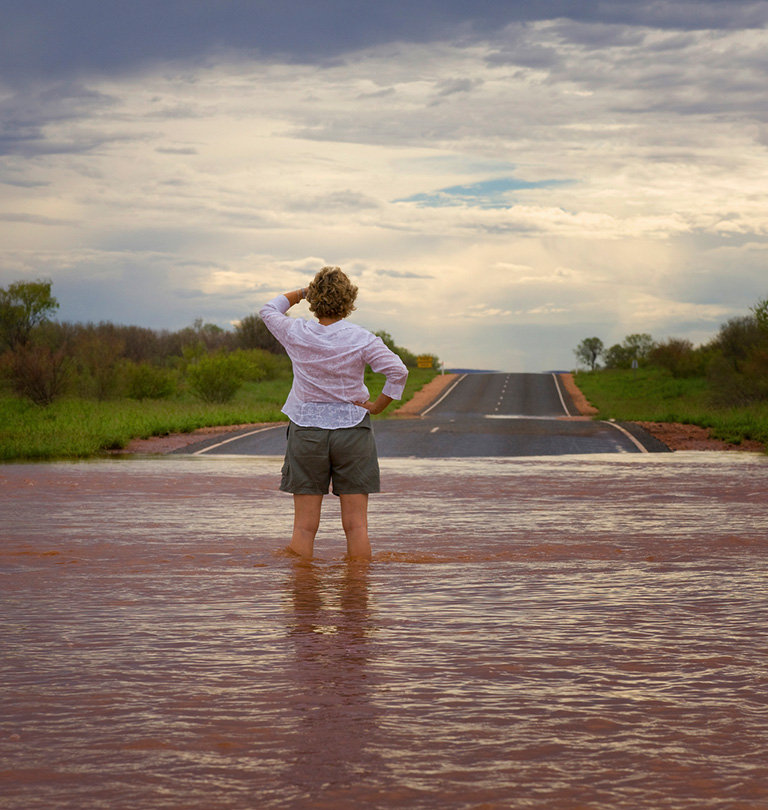 Woman standing on flooded road