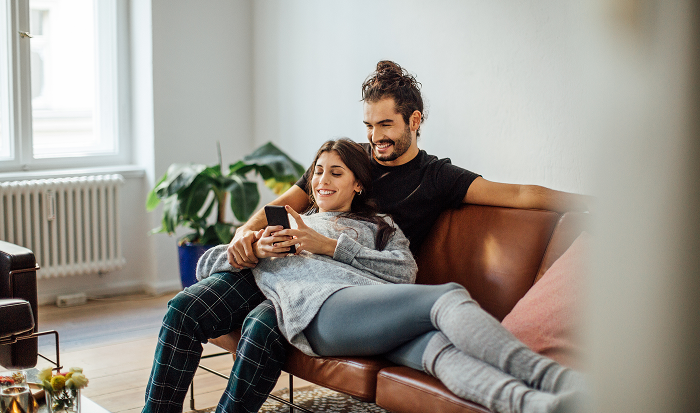 Couple sitting on leather couch