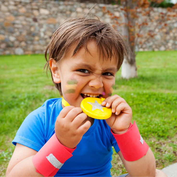 Boy biting medal