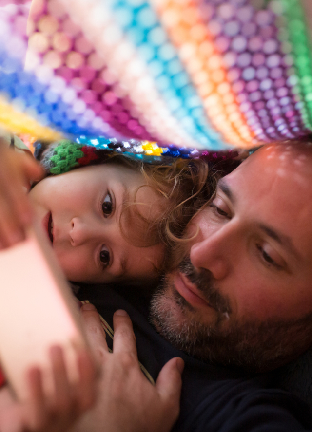 Father and child looking at phone