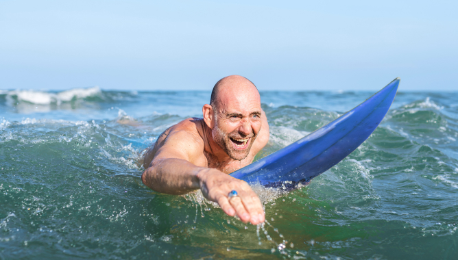 Man paddling on surfboard in ocean