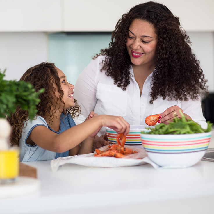 First Nations mum making prawn salad with her young daughter