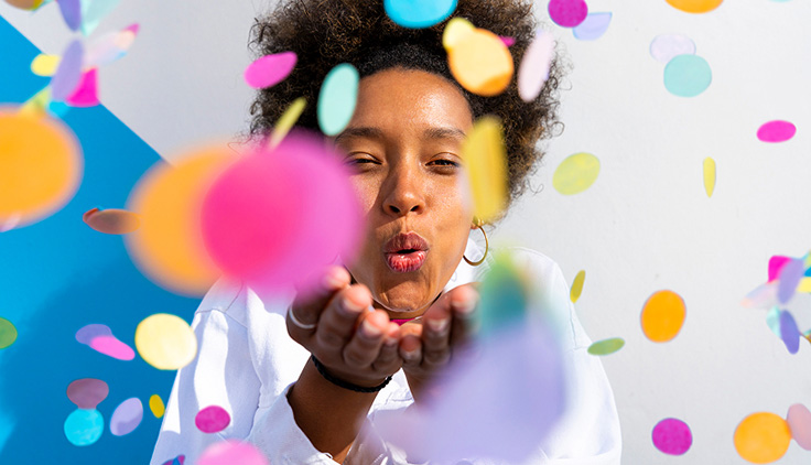 Woman blowing confetti