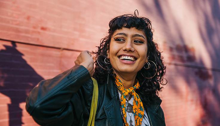 Woman holding bag over shoulder